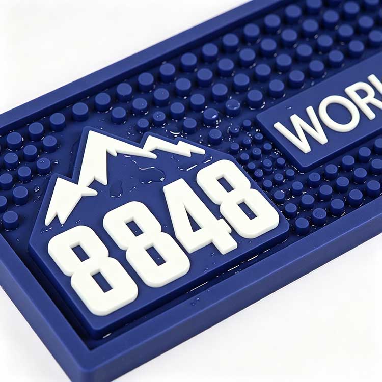 Custom LED Bar Spill Mat Battery Operated Illuminated Waterproof Non-Slip Spill Control Bar Runner, macro close up of 8848 embossed mountain logo, raised anti-slip nubs and water resistant silicone surface