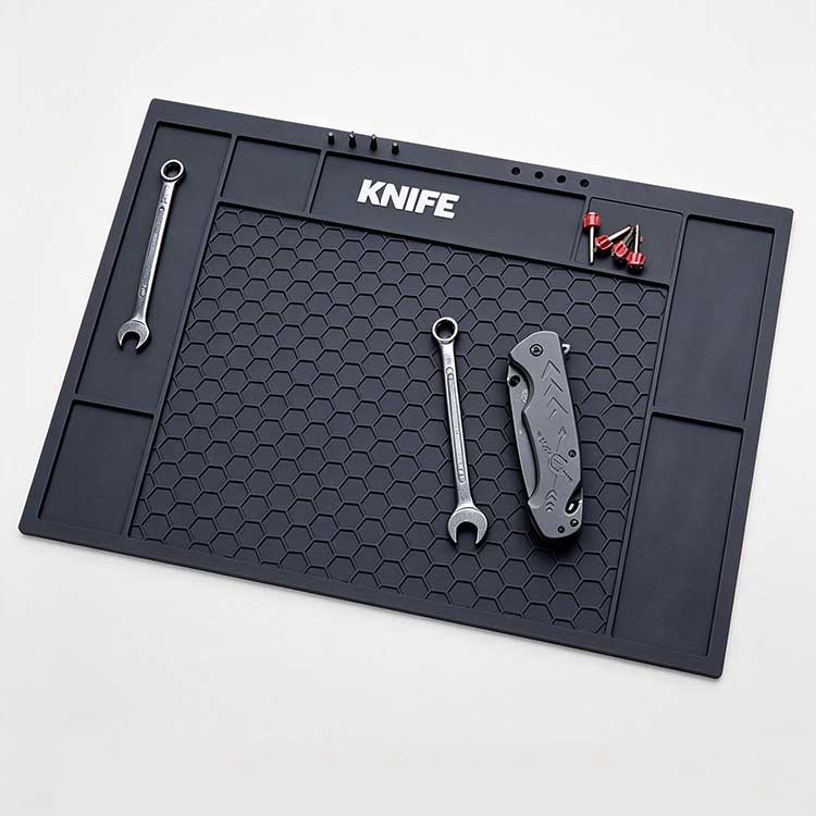 Black hexagonal honeycomb knife tool mat with branding zone and storage slots.