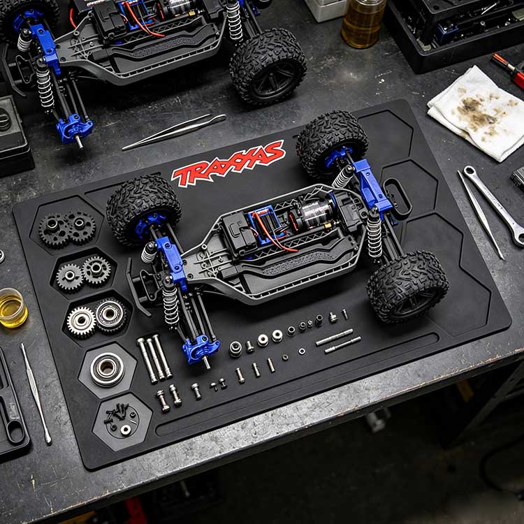 RC takedown mat supporting a 1/10 scale buggy chassis during rebuild.