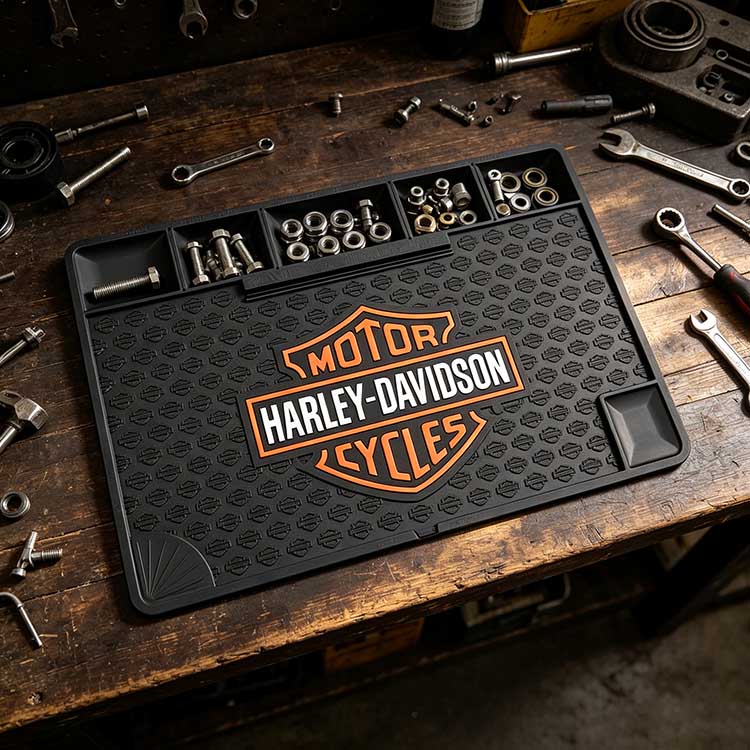 Rubber utility mat laid on wooden workbench sorting motorcycle bolts nuts sockets in integrated storage compartments