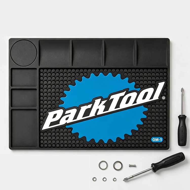 Circular bottle holder recess on a bicycle tool mat for degreaser and solvent.
