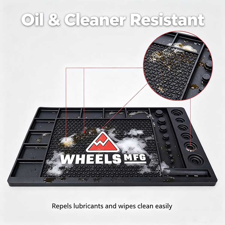 Oil and degreaser resistant rubber workbench mat showing repelled lubricants and cleaners being wiped away