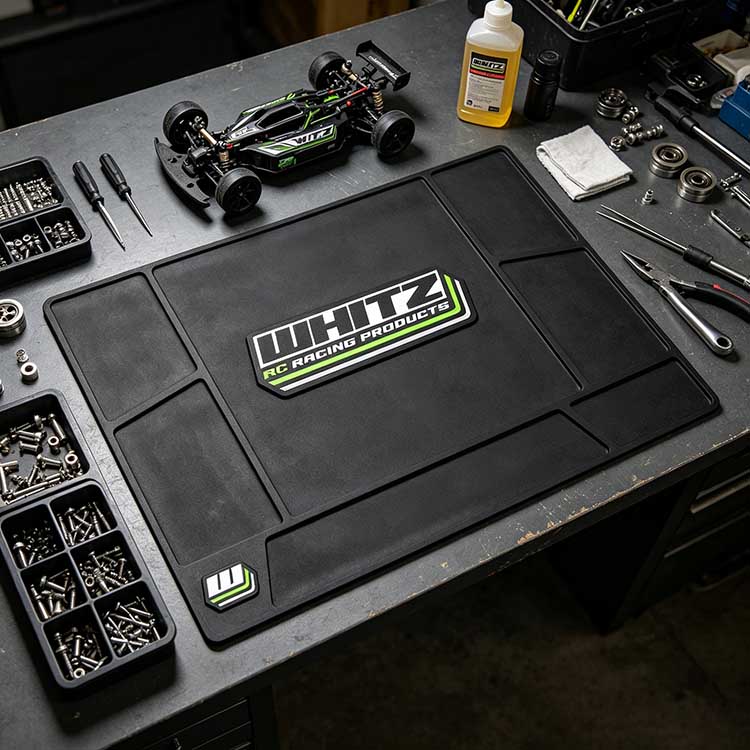 Heavy-duty RC mat organizing a buggy, tools, and screws during a workshop assembly