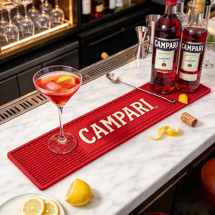 PVC bar mat on a marble bar with a cocktail glass, bottles, and lemon peel.