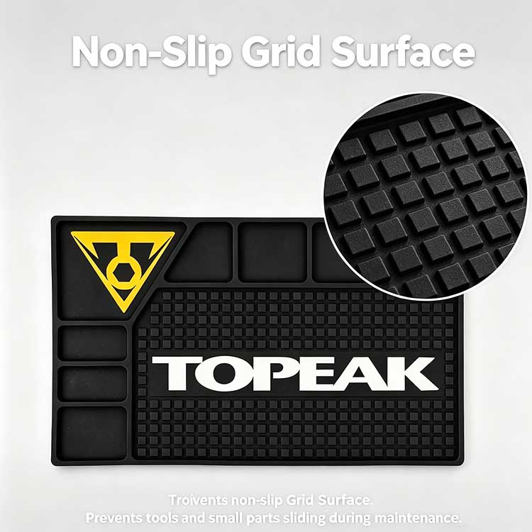 The non-slip raised square grid surface on the bike workbench rubber mat preventing tools and small parts from sliding