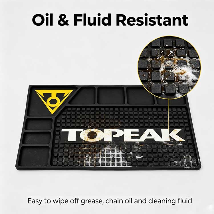 Oil and fluid resistant bike workbench rubber mat demonstrating repellency against chain oil and cleaning fluid