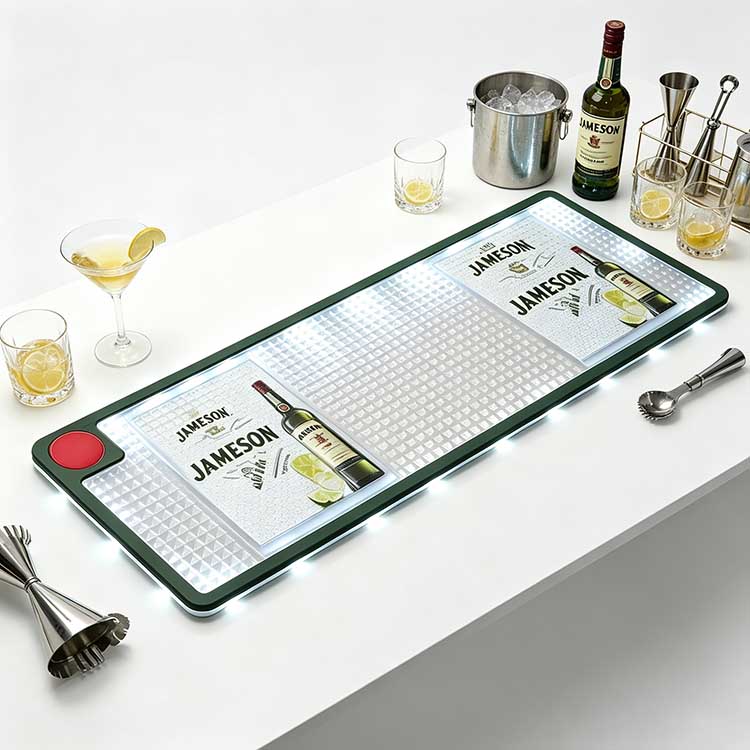 Jameson Branded LED Bar Mat Full Studio Shot with Bar Tools & Cocktail Glasses White background studio photo of branded LED bar mat printed with Jameson whiskey logo, waterproof non-slip spill-proof illuminated bar drip runner with glowing LED edge, arranged with cocktail glasses, whiskey bottle, metal jigger and ice bucket for bar counter use