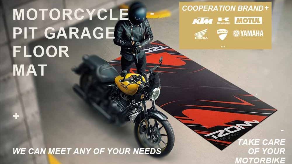 A rider standing next to a yellow motorcycle on a large custom black and red pit mat in a garage, featuring top motorcycle brand logos.