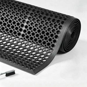 Rolled heavy-duty black rubber drainage mat with uniform open-hole design, ready for OEM branding.
