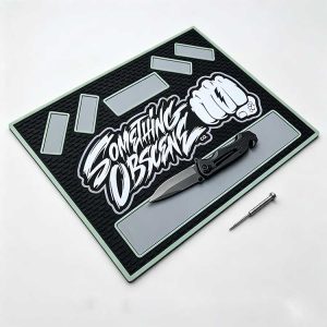 Tactical silicone EDC tray with bold black mint green design and knife.