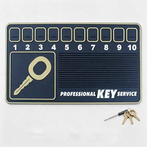 Close-up view of a key service mat featuring 10 numbered slots for organizing lock pins, springs, and key parts.