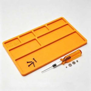 Silicone RC disassembly mat with molded organizer slots holding screws and small gears.