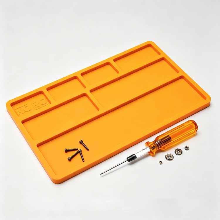 RC Silicone Disassembly Mat Organizer Silicone RC disassembly mat with molded organizer slots holding screws and small gears.
