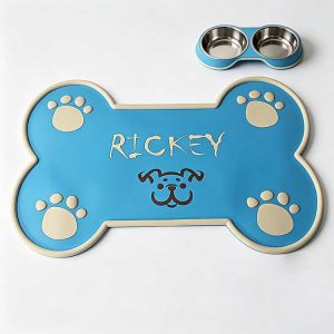 Blue bone-shaped silicone dog feeding mat with custom embossed name and paw design.