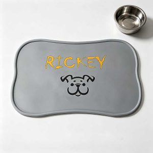 Grey silicone pet placemat with custom embossed name and dog logo design.